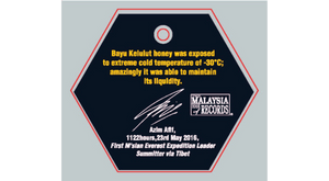 Hexagonal sign with text about honey exposure to extreme cold temperatures, featuring the Malaysia Records logo.
